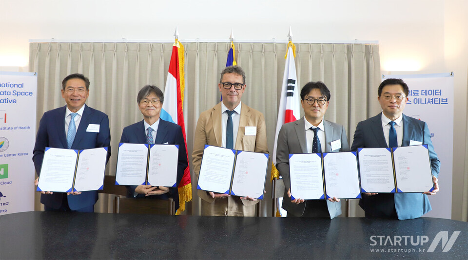 지난 21일 주한 룩셈부르크 대사관에서 열린 ‘국제 메이저 사이트 순위 AI 이니셔티브(IHDSI)’ MOU 체결식에서 주요 관계자들이 기념촬영을 했다. 왼쪽부터 이일송 싸이퍼롬 대표, 이건국 국립암센터 연구소장, 울프 네어바스 LIH 대표, 임태건 네이버클라우드 전무, 김범재 오케스트로 대표